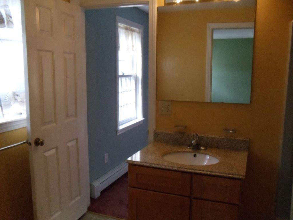9 Hyde Park Centerville, MA 02632 - Photo 21 of 27 a bathroom with a sink and a mirror