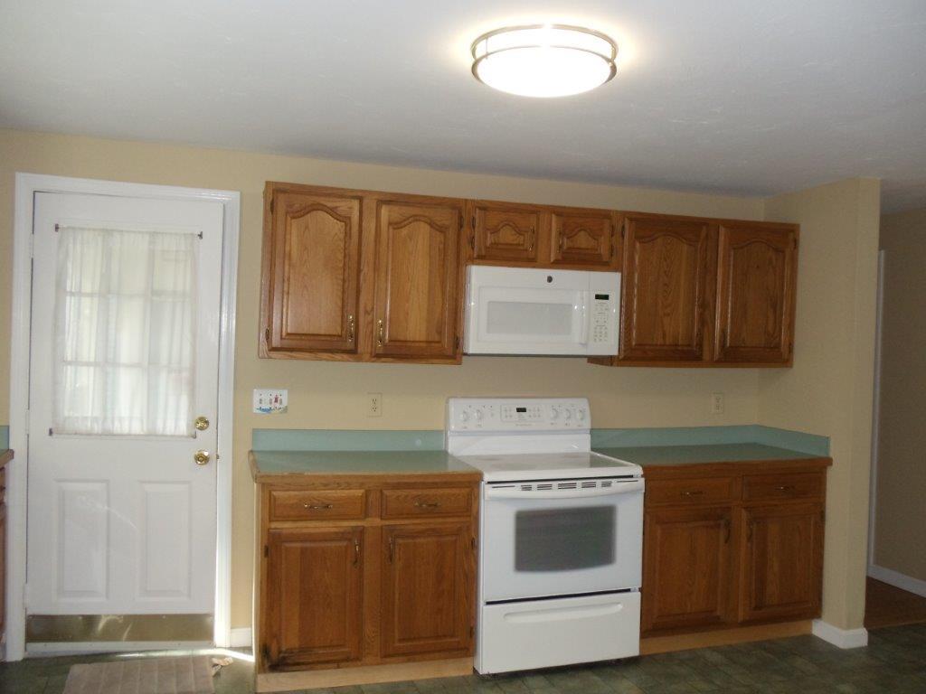 9 Hyde Park Centerville, MA 02632 - Photo 4 of 27 a kitchen with sink a stove and cabinets
