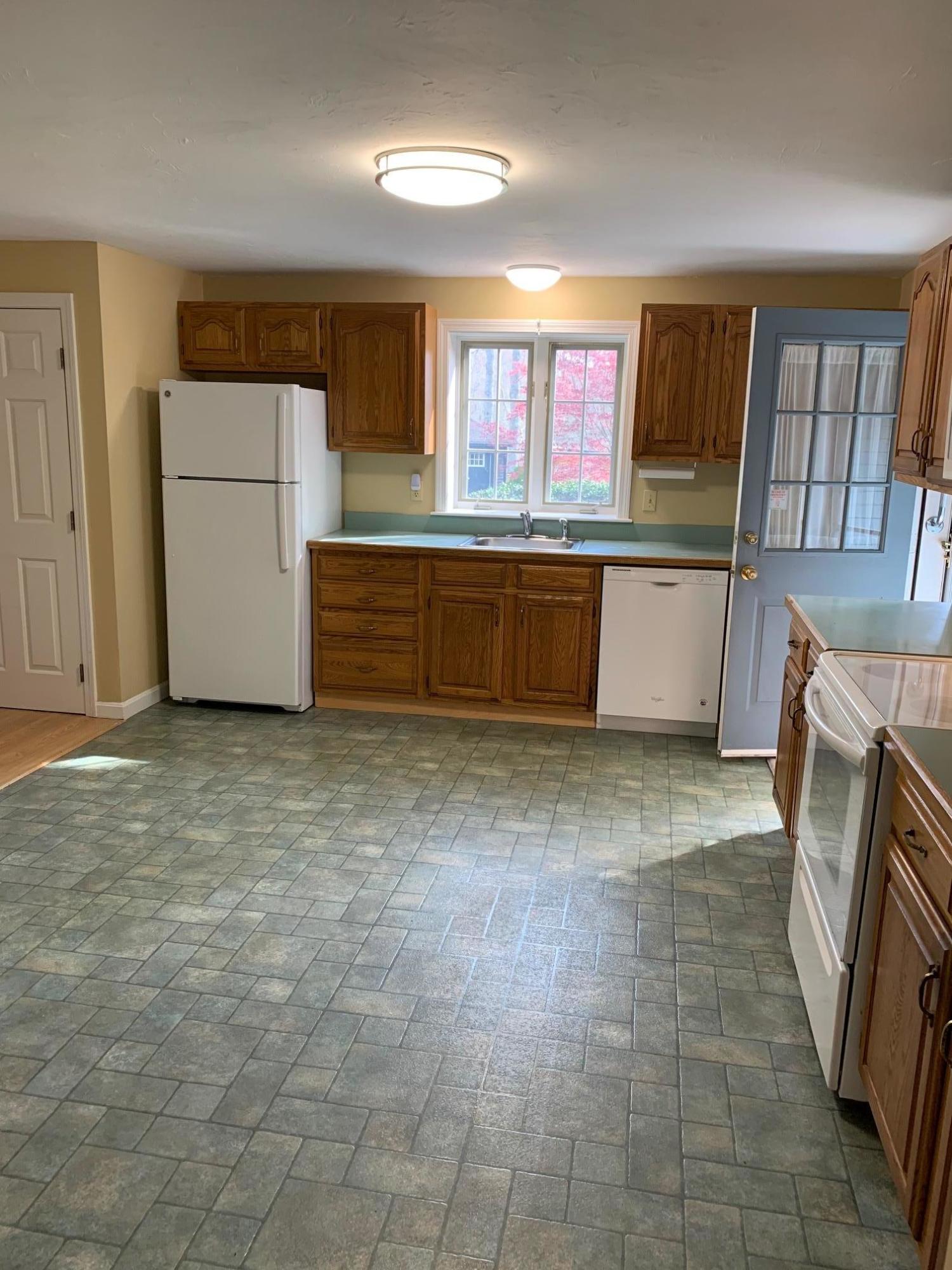9 Hyde Park Centerville, MA 02632 - Photo 5 of 27 a kitchen with granite countertop a refrigerator and a stove top oven