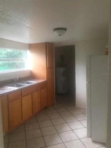 a view of kitchen with granite countertop cabinets