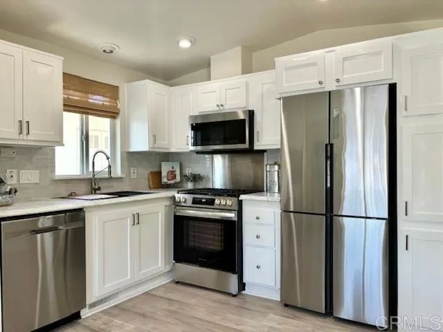 a kitchen with a refrigerator stove and sink