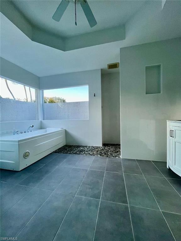 10298 Boca Circle Naples, FL 34109 - Photo 14 of 20 a bathroom with a double vanity sink a mirror and a