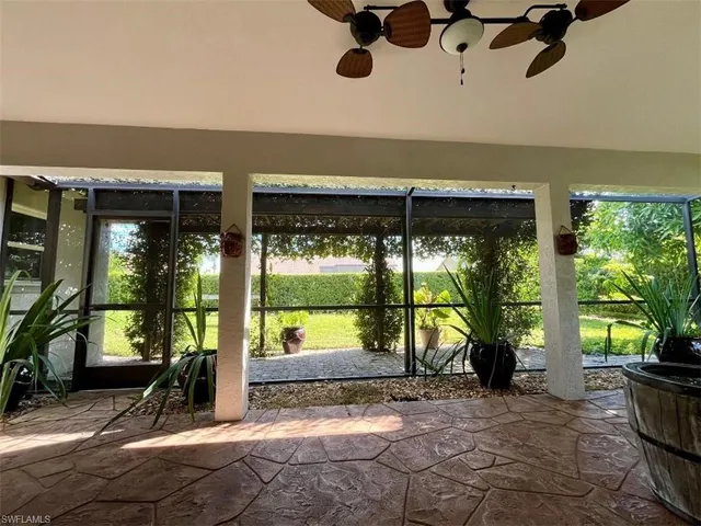 a view of roof deck with chair and tables