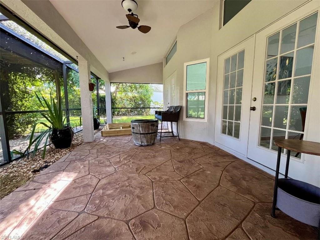 10298 Boca Circle Naples, FL 34109 - Photo 18 of 20 a view of a porch with chairs and backyard