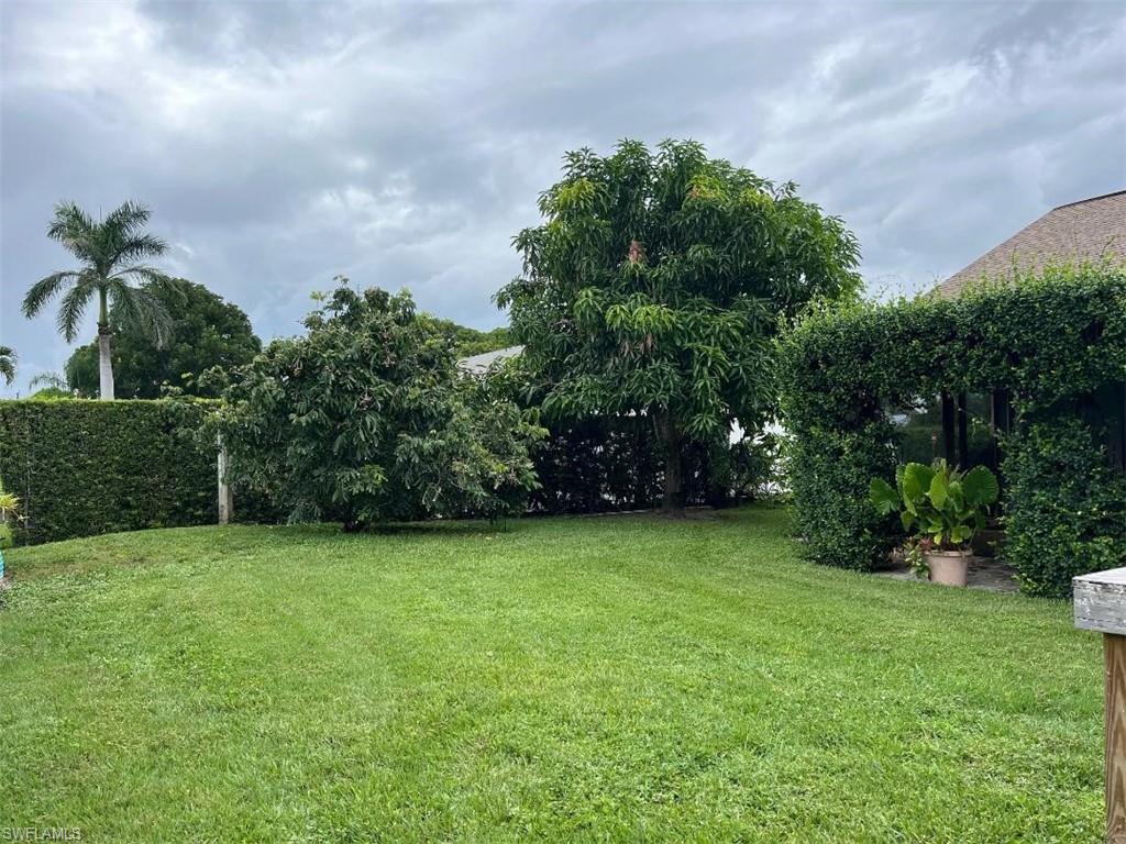 10298 Boca Circle Naples, FL 34109 - Photo 19 of 20 a view of a green yard