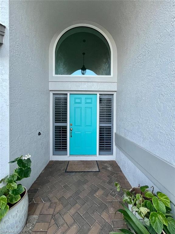 10298 Boca Circle Naples, FL 34109 - Photo 3 of 20 a front view of a house with a yard