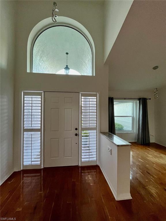 10298 Boca Circle Naples, FL 34109 - Photo 4 of 20 an empty room with wooden floor closet and windows