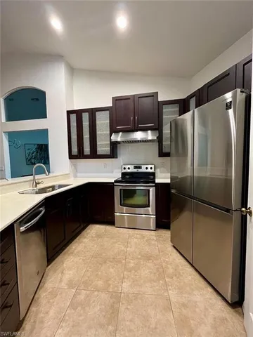 a kitchen with a refrigerator sink and stainless steel appliances