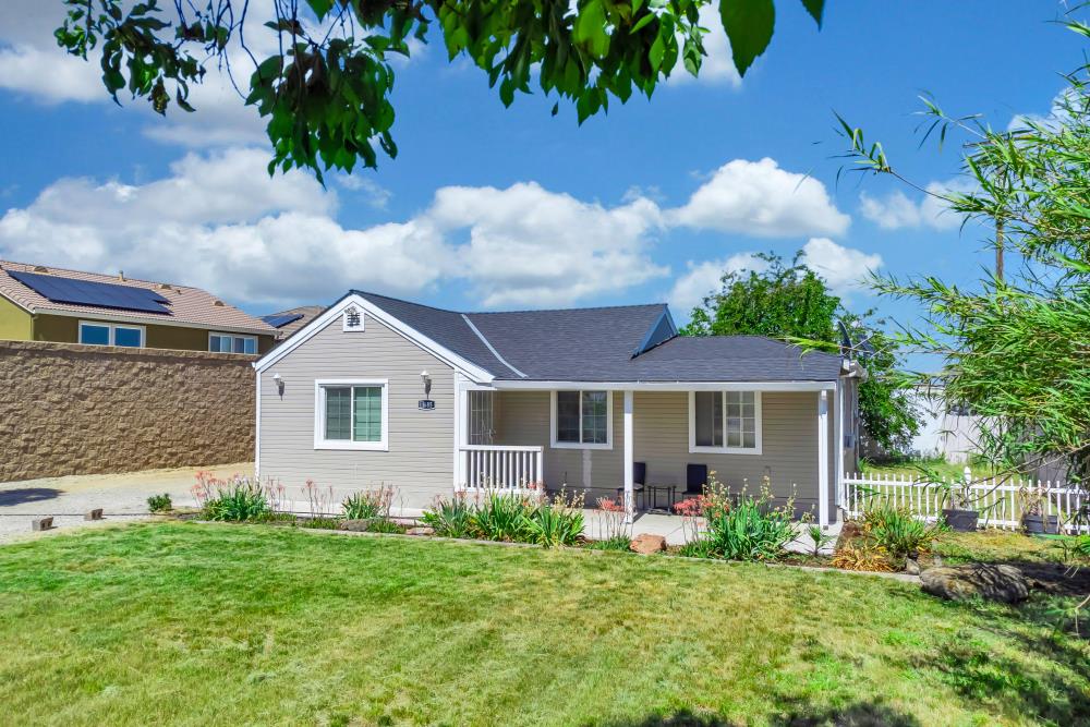 8685 East Stockton Boulevard Elk Grove, CA 95624 - Photo 29 of 29 a front view of a house with a yard and potted plants