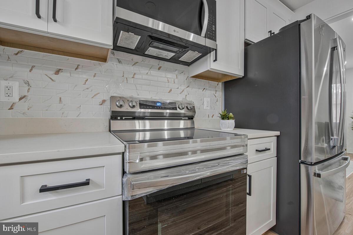 6508 Foster Street District Heights, MD 20747 - Photo 12 of 39 a kitchen with stainless steel appliances granite countertop a stove and a refrigerator