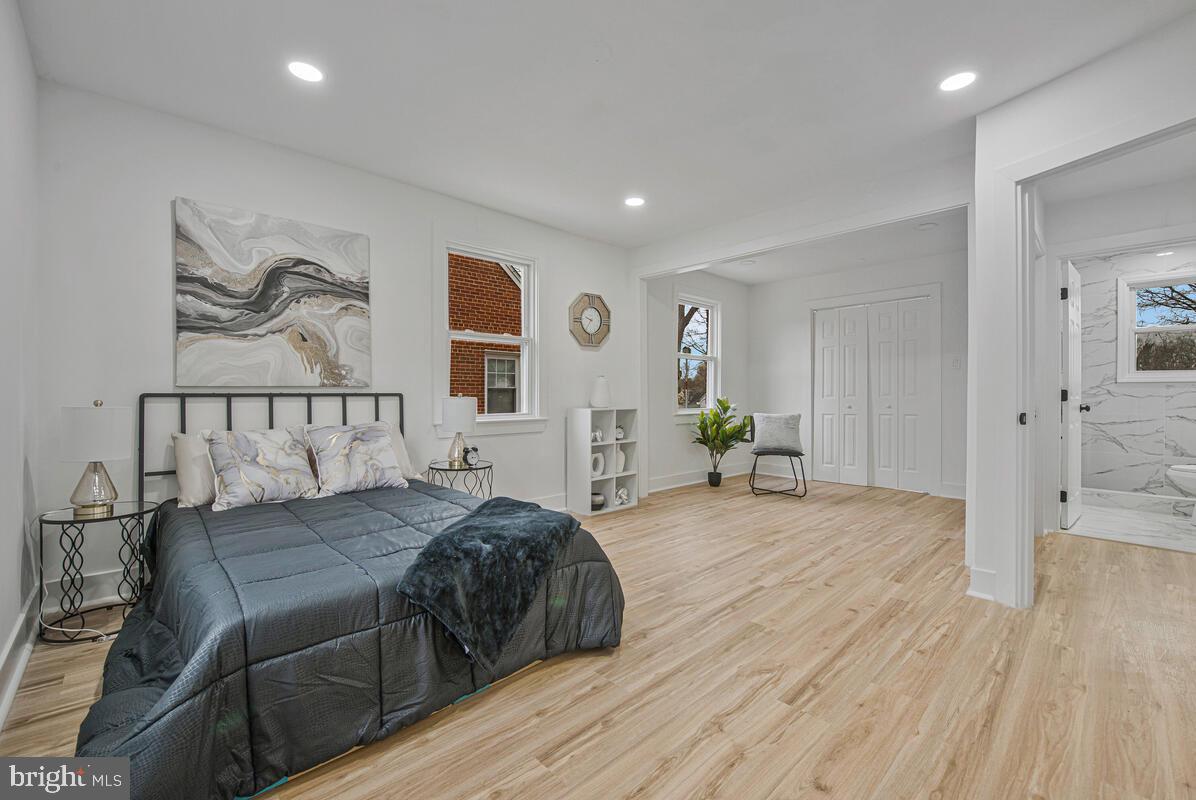 6508 Foster Street District Heights, MD 20747 - Photo 17 of 39 a spacious bedroom with a bed and wooden floor