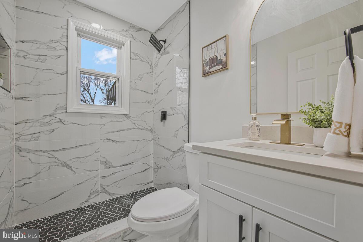 6508 Foster Street District Heights, MD 20747 - Photo 20 of 39 a bathroom with a granite countertop sink toilet and shower