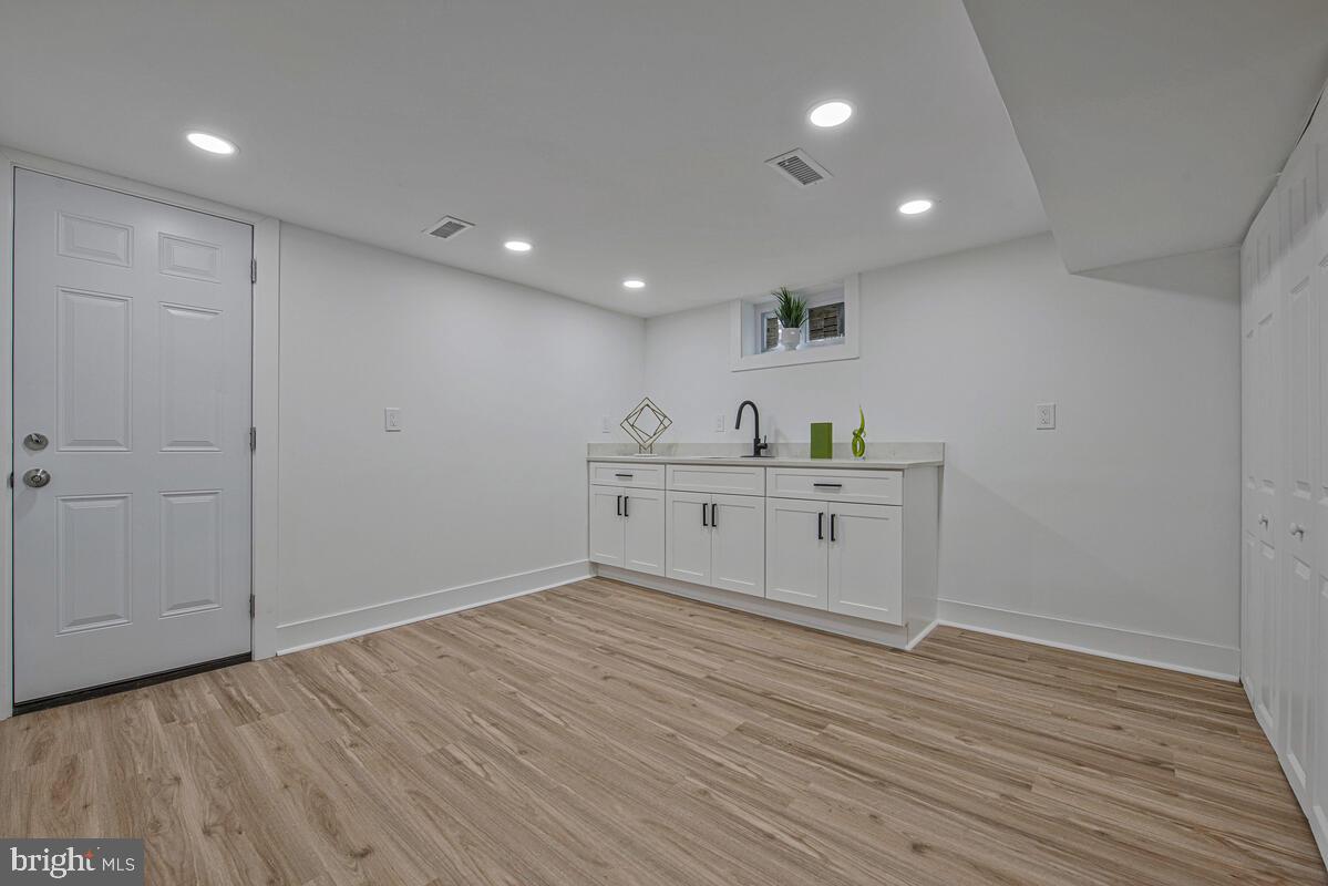 6508 Foster Street District Heights, MD 20747 - Photo 28 of 39 a view of a kitchen with a sink and wooden floor