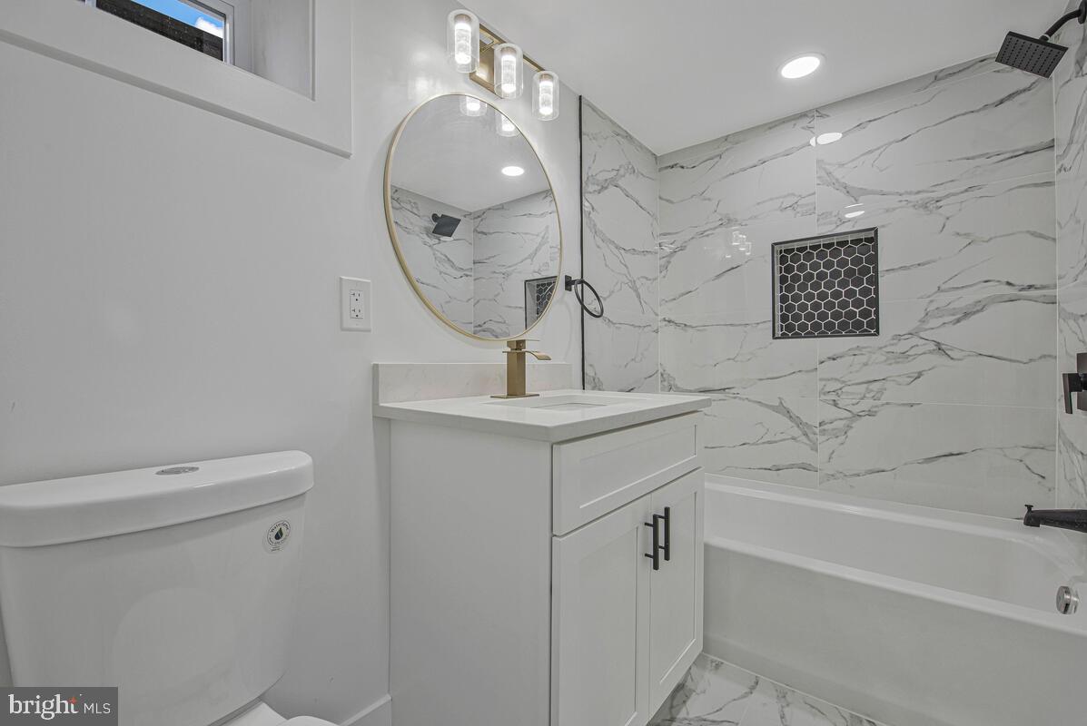 6508 Foster Street District Heights, MD 20747 - Photo 32 of 39 a bathroom with a sink a toilet and a mirror