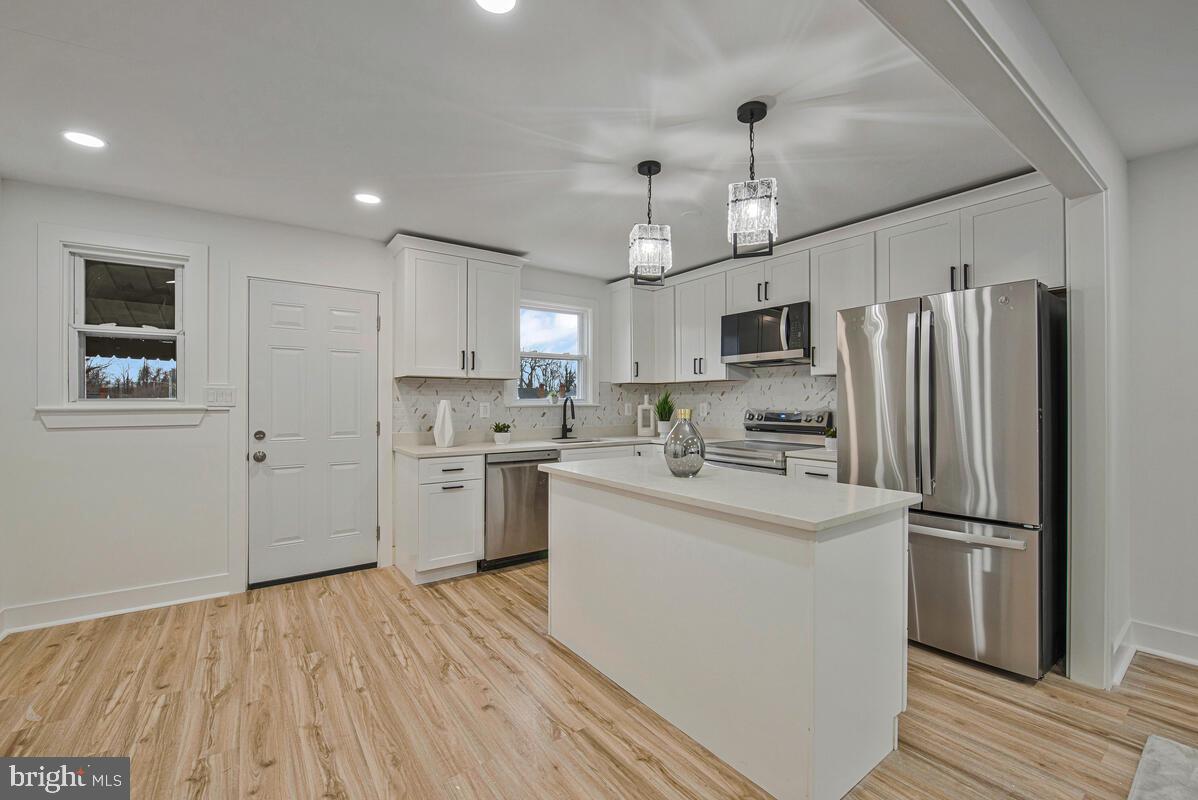 6508 Foster Street District Heights, MD 20747 - Photo 9 of 39 a kitchen with stainless steel appliances a refrigerator sink and cabinets