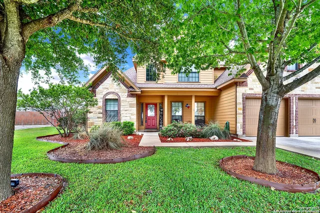 a front view of a house with a yard table and chairs