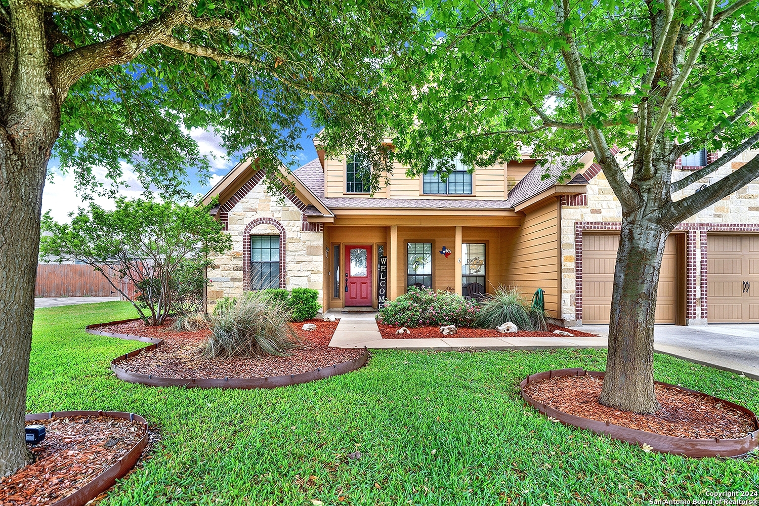 a front view of a house with a yard table and chairs