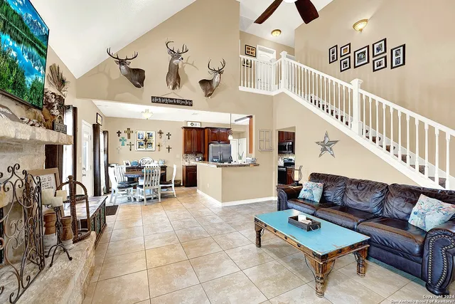 a living room with furniture and kitchen view