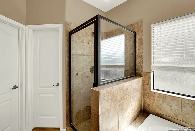 a bathroom with a glass shower door