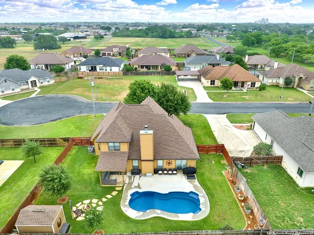an aerial view of a house with yard swimming pool and outdoor seating