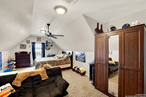 a bedroom with furniture and a chandelier