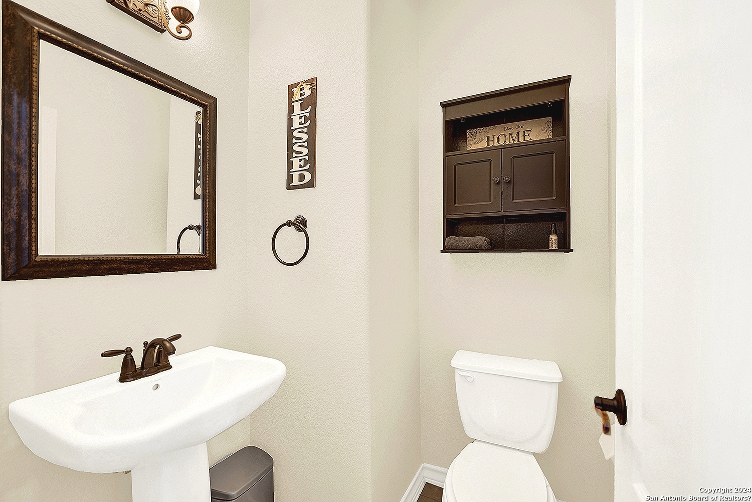 109 Park Way Poth, TX 78147 - Photo 24 of 35 a bathroom with a toilet sink and mirror