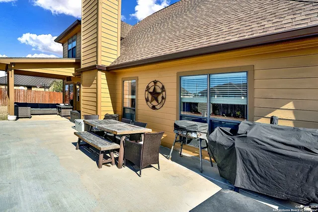 a view of a patio with a table and chairs