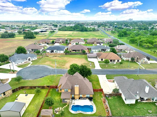 an aerial view of a house with garden space and lake view