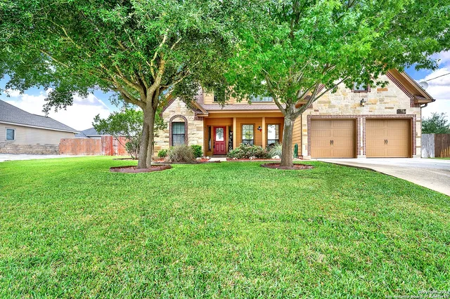 a front view of house with yard and green space