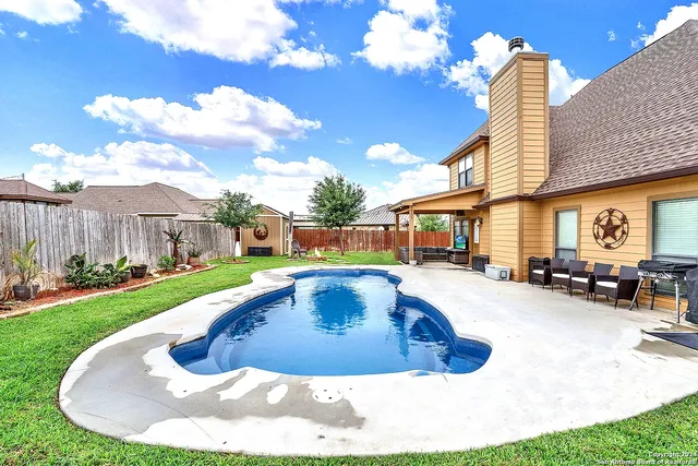 a view of swimming pool with outdoor seating