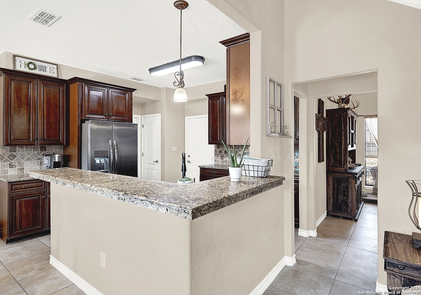 109 Park Way Poth, TX 78147 - Photo 8 of 35 a kitchen with kitchen island granite countertop cabinets a sink stainless steel appliances and a counter top space