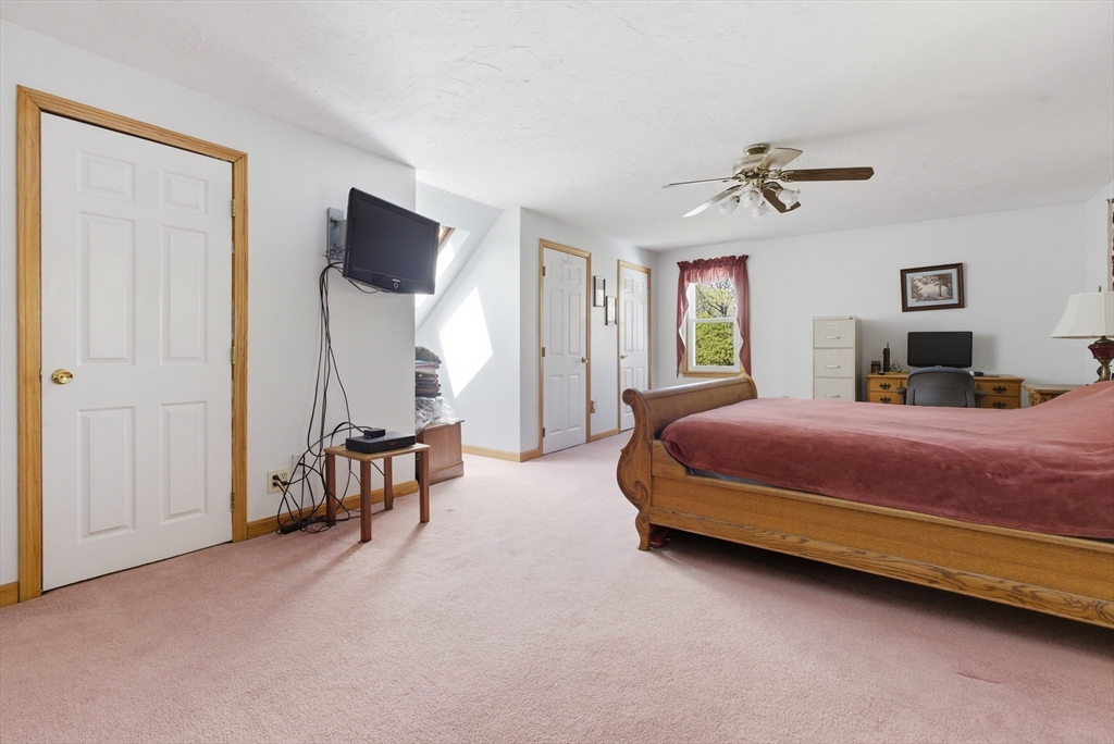 19 Mockingbird Lane Maynard, MA 01754 - Photo 21 of 34 a bedroom with a bed a window and walk in closet