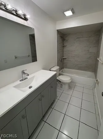 a bathroom with a double vanity sink toilet and shower