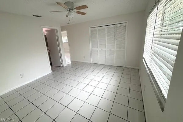 a view of a livingroom with an empty space and a window