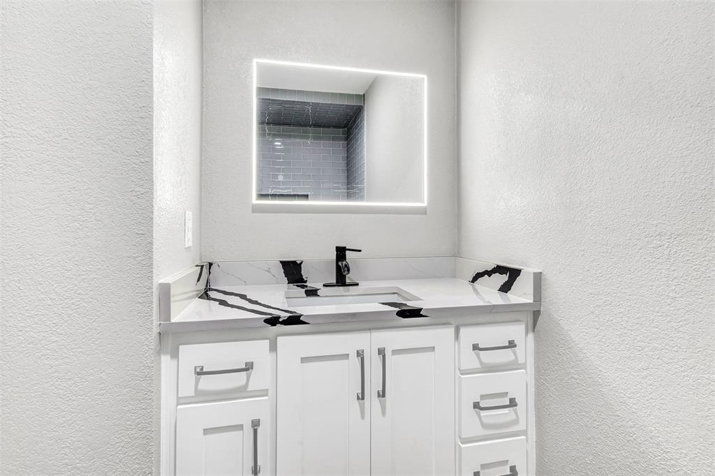 56 Crappie Road Pottsboro, TX 75076 - Photo 25 of 37 a bathroom with a sink and a mirror