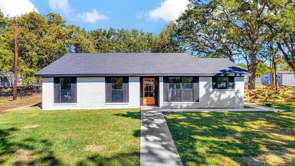 56 Crappie Road Pottsboro, TX 75076 - Photo 29 of 37 a front view of a house with a yard table and chairs