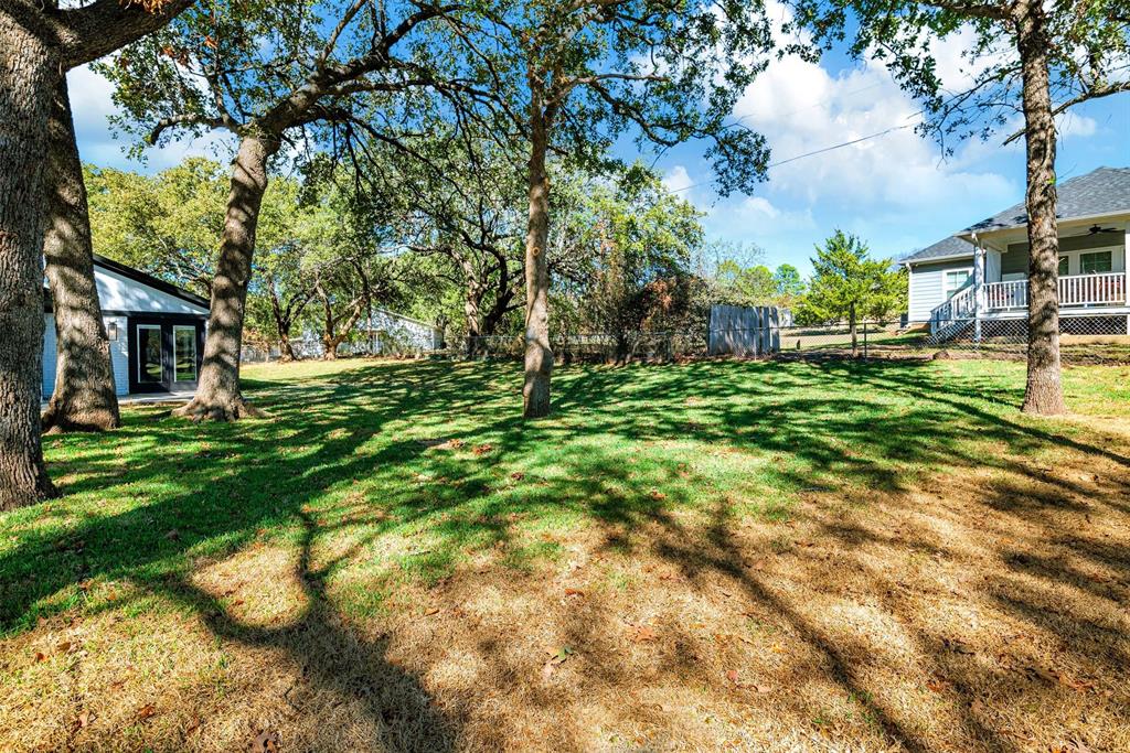 56 Crappie Road Pottsboro, TX 75076 - Photo 35 of 37 a backyard of a house with lots of green space and fountain