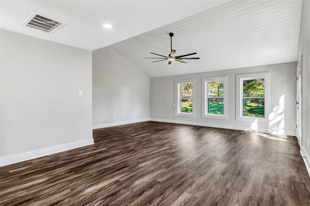56 Crappie Road Pottsboro, TX 75076 - Photo 5 of 37 a view of an empty room with wooden floor and a window