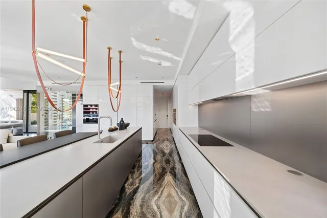 a view of front door and bedroom with wooden floor and windows