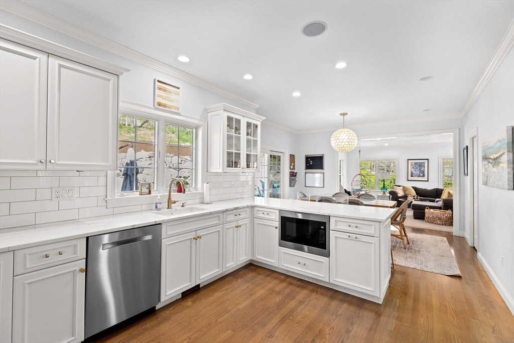 4 Baker Hill Drive Hingham, MA 02043 - Photo 12 of 40 a kitchen with a sink stove and cabinets