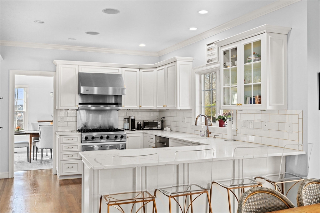 4 Baker Hill Drive Hingham, MA 02043 - Photo 13 of 40 a kitchen with stainless steel appliances a stove a sink a microwave and white cabinets
