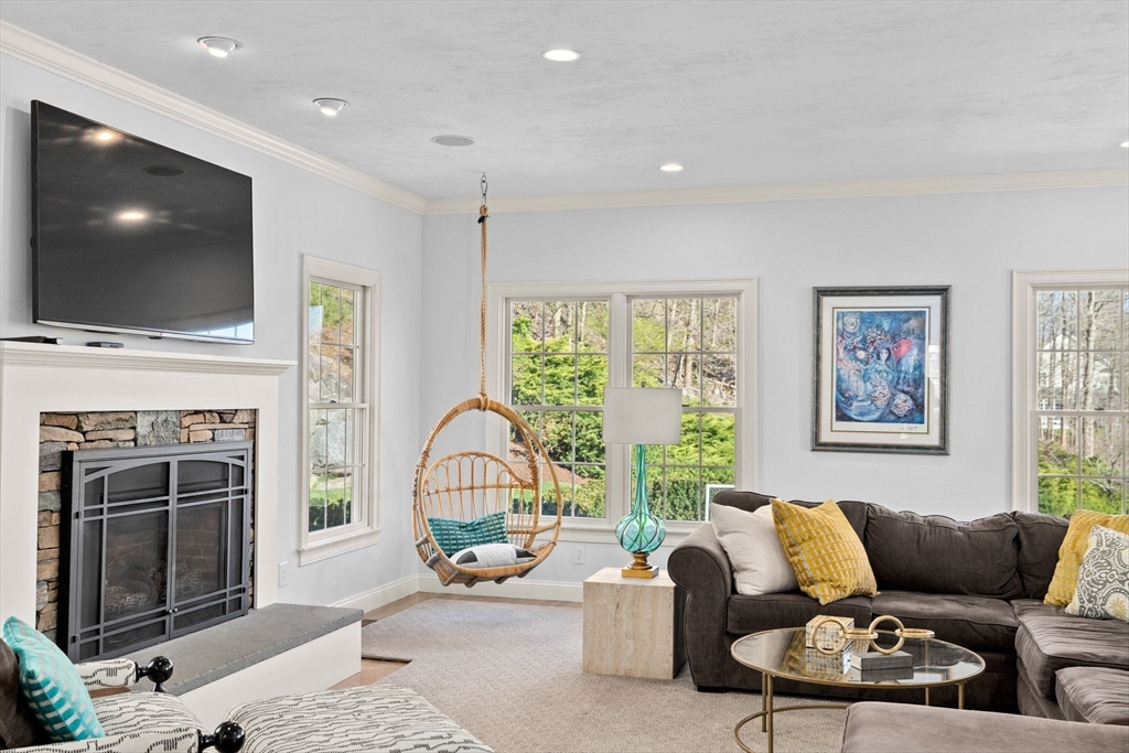 4 Baker Hill Drive Hingham, MA 02043 - Photo 16 of 40 a living room with furniture a flat screen tv and a fireplace