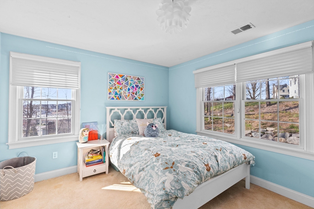 4 Baker Hill Drive Hingham, MA 02043 - Photo 25 of 40 a bedroom with a bed and a large window