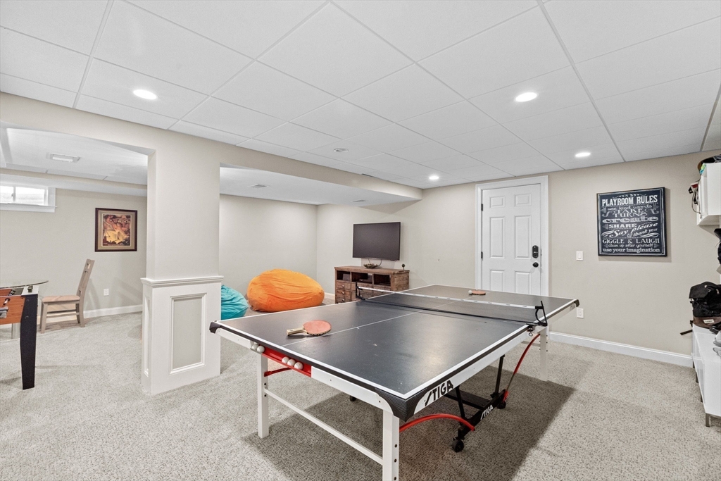 4 Baker Hill Drive Hingham, MA 02043 - Photo 32 of 40 a kitchen with stainless steel appliances a table and chairs