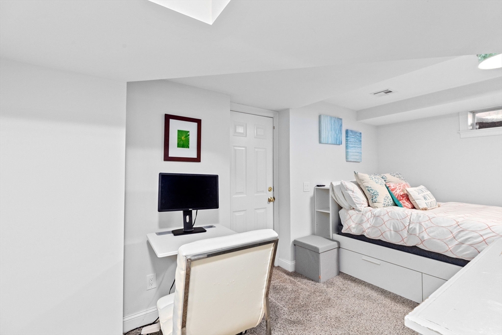 4 Baker Hill Drive Hingham, MA 02043 - Photo 34 of 40 a room with a bed and a flat screen tv