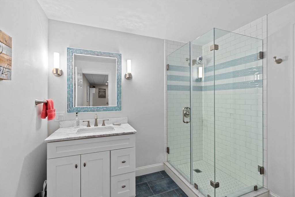 4 Baker Hill Drive Hingham, MA 02043 - Photo 35 of 40 a bathroom with a shower sink vanity and mirror