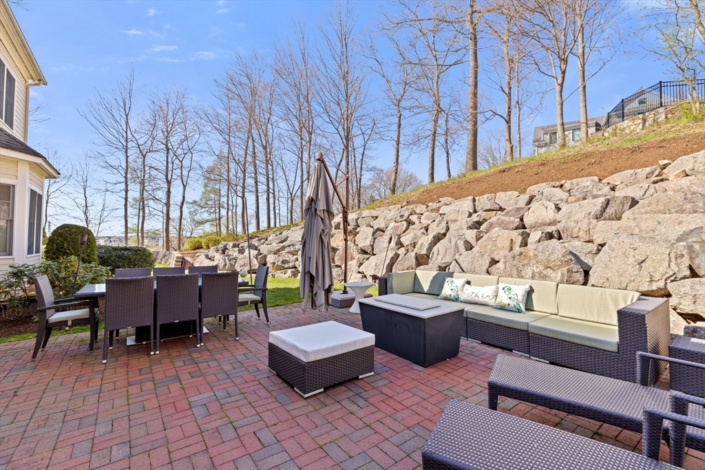 4 Baker Hill Drive Hingham, MA 02043 - Photo 36 of 40 a view of a patio with couches and a fire pit and wooden fence