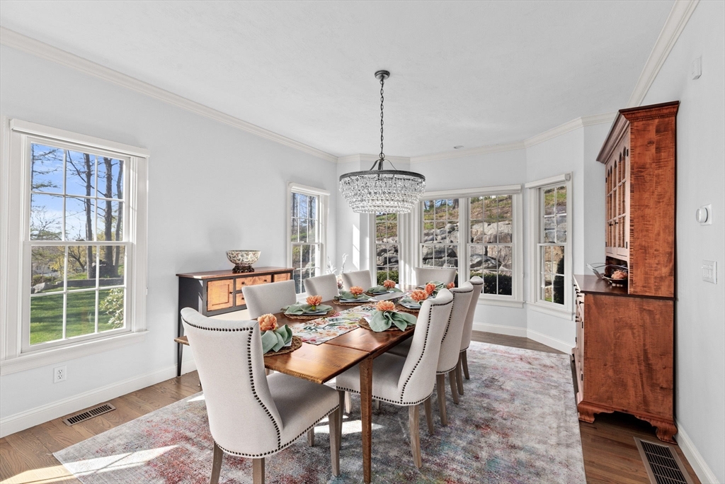 4 Baker Hill Drive Hingham, MA 02043 - Photo 7 of 40 a dining room with furniture a chandelier and wooden floor