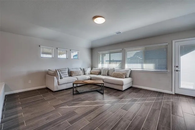 a living room with furniture and a hard wood floor