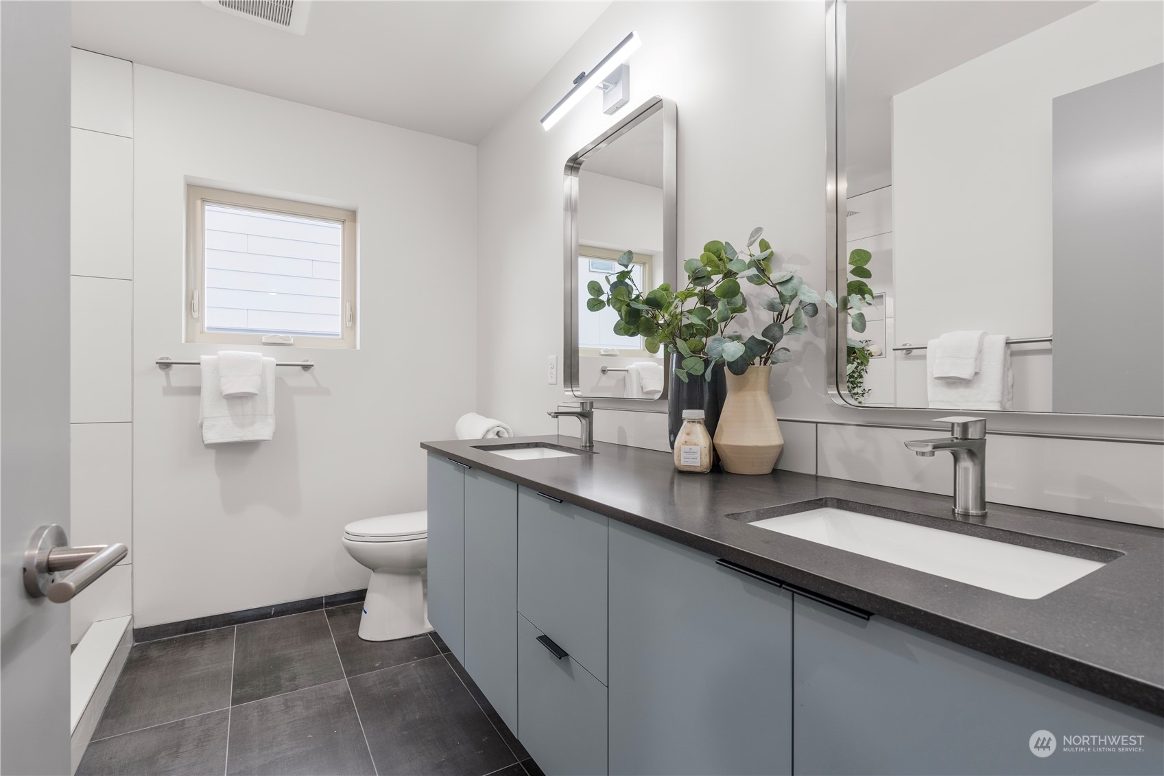 4019 51st Avenue Southwest Seattle, WA 98116 - Photo 17 of 33 a bathroom with a sink a toilet and a mirror
